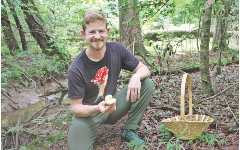 Certified mushroom identification expert and Mindfull Mycology owner Sam Blackstone shows off a wild mushroom he spotted while foraging on his 40-acre property just outside of Dahlonega.