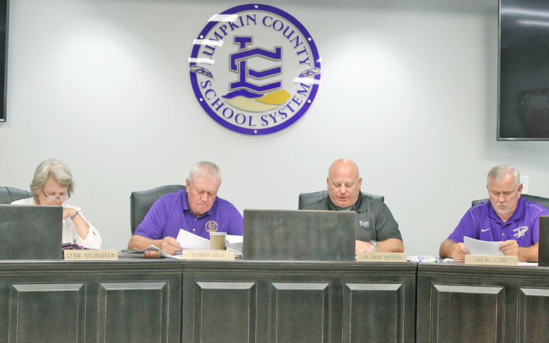 Lumpkin County School Board members compare notes as they deliberate the tentative millage rate for Fiscal Year 2024. Pictured (from left) are Lynn Sylvester, Chairman Bobby Self, Superintendent Rob Brown and Jim McClure.