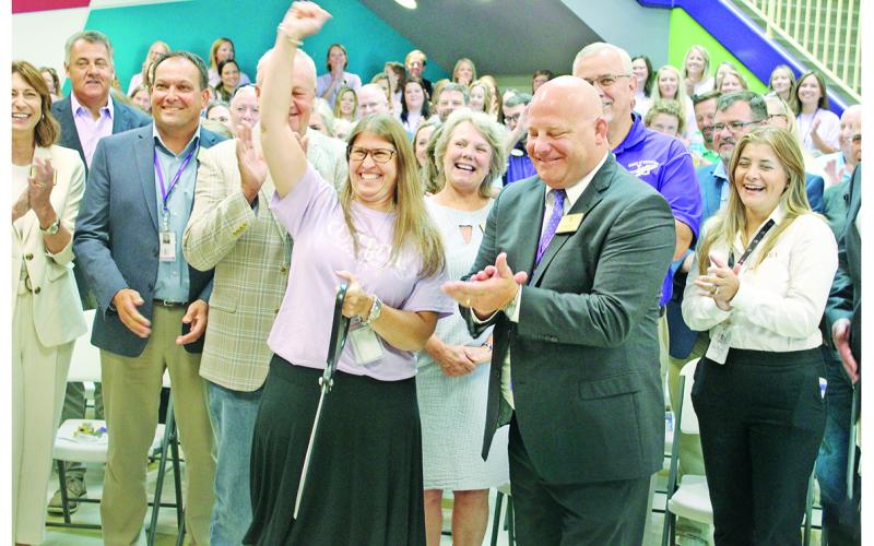 Cottrell Elementary Principal Stacie Gerrells celebrates next to Superintendent Rob Brown and other officials after cutting the ceremonial red ribbon to mark the grand opening of the new school.