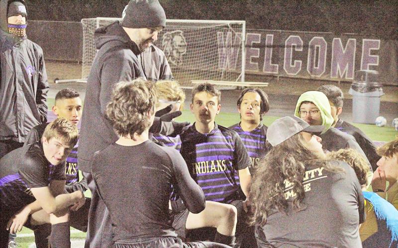 Head Coach Brent Howell talks to his Lumpkin soccer team following a game last season.