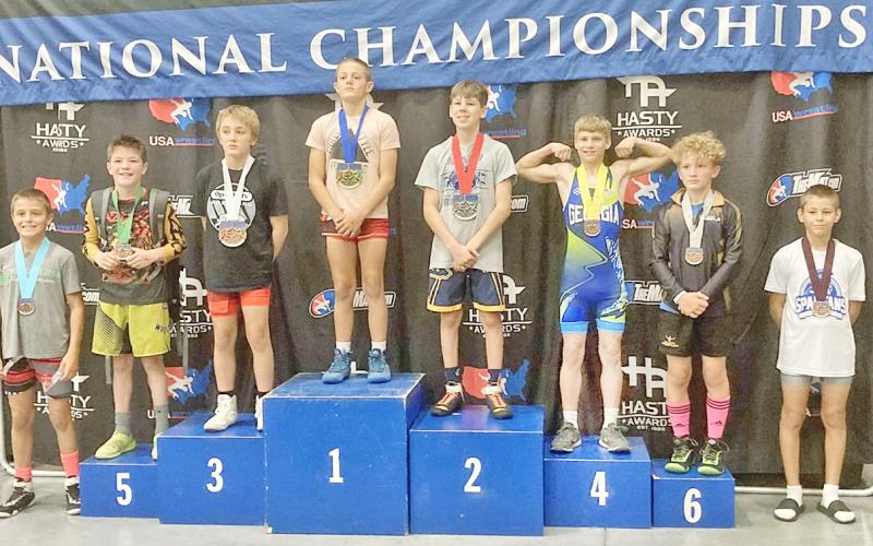 Lumpkin’s Liam Nielsen stands on the 4th place podium at the Kids Nationals competition.