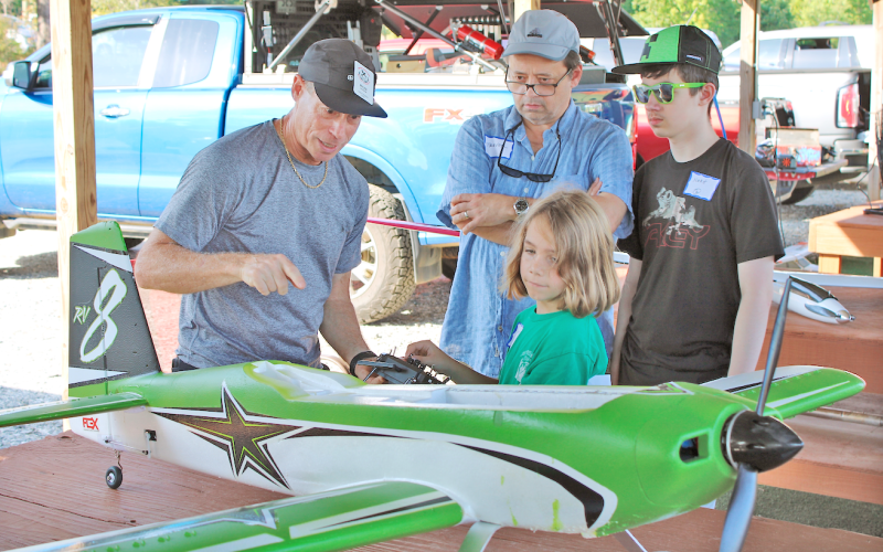 NGMA member Ron Gaynor explains the basics of lift, weight, drag and thrust to Judah Payne, 7, Noah Wade, 14, and Trevor Wade during the club’s recent Junior Flight Academy event.