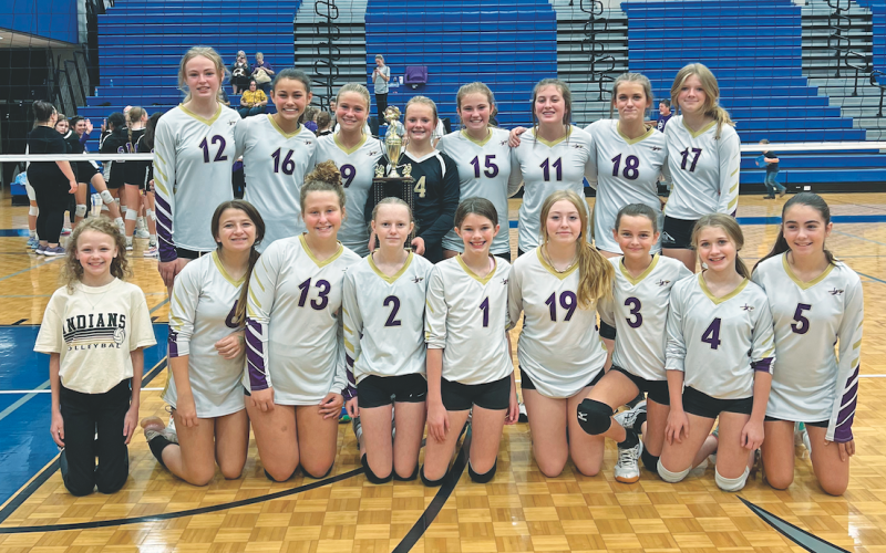 The Lumpkin County Middle School volleyball team celebrates with their new Mountain League Championship trophy.