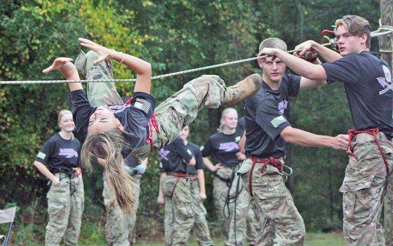 McKinzley Cootware, Sid Braswell and Colton Gilreath work together as a team during the rope bridge event.