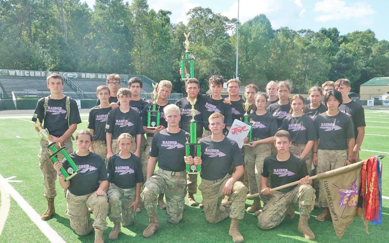 The Lumpkin Raider squad with their newly earned trophy after a hard-fought competition at Grayson High School.