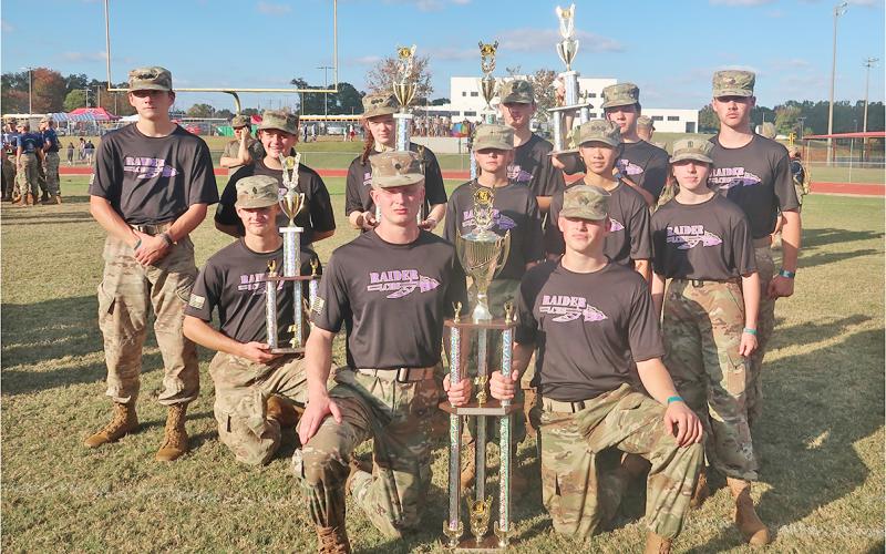 The Lumpkin County Raiders team shows off their new hard-earned championship trophies.