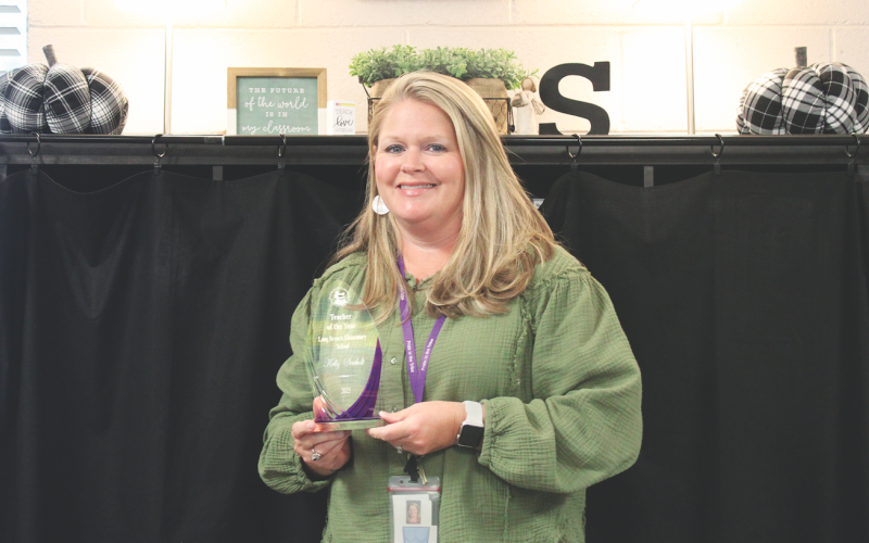 Kelly Seabolt displays her 2025 Teacher of the Year award for Long Branch Elementary.
