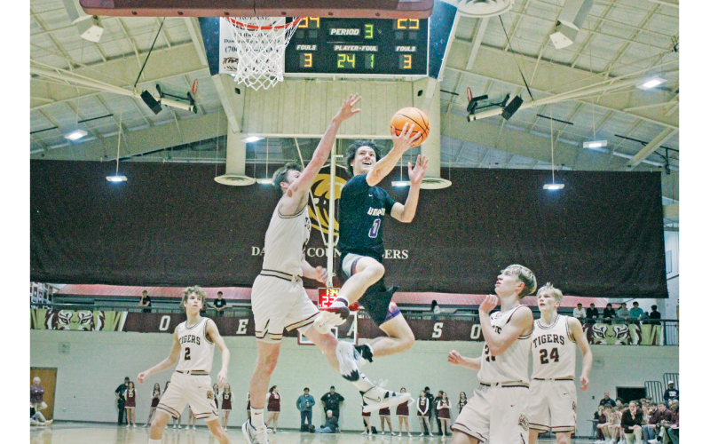 Lumpkin County junior Cal Faulkner drives for a big basket over region rival Dawson County last week. (Photo by Eligha Roper/The Nugget)