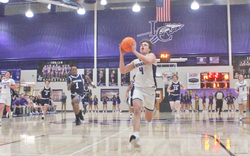 Lumpkin County’s Walker Scott races down the court for a breakaway layup.