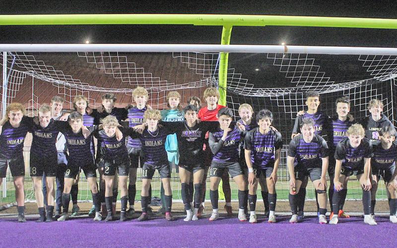 The LCHS varsity boys team celebrates following their big win over Calhoun.