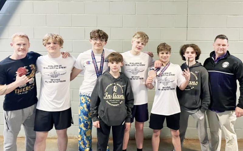 The Lumpkin boys’ wrestling squad gathers alongside the coaches.