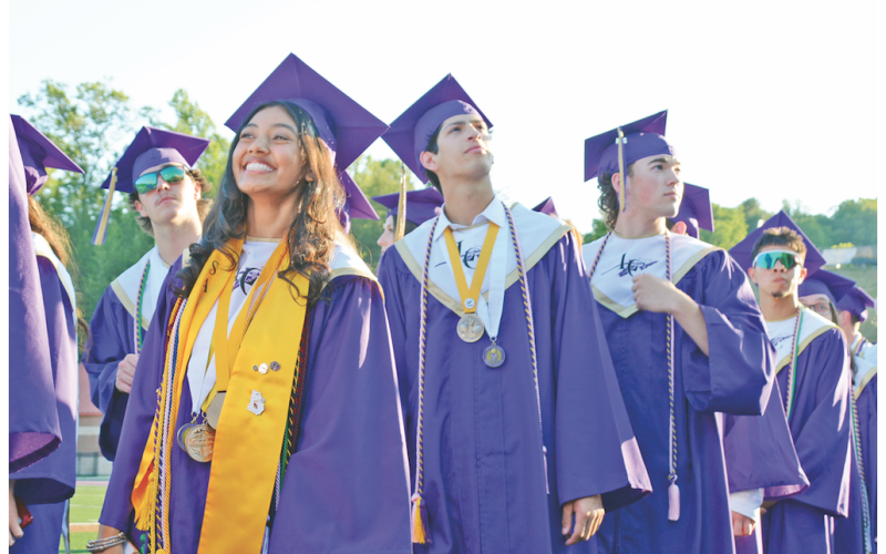 Pictured (from left) Salutatorian Zoha Munshi, Alejandro Narvaez and Duke Nelson react to the cheers of the crowd as the seniors enter the commencement ceremony.