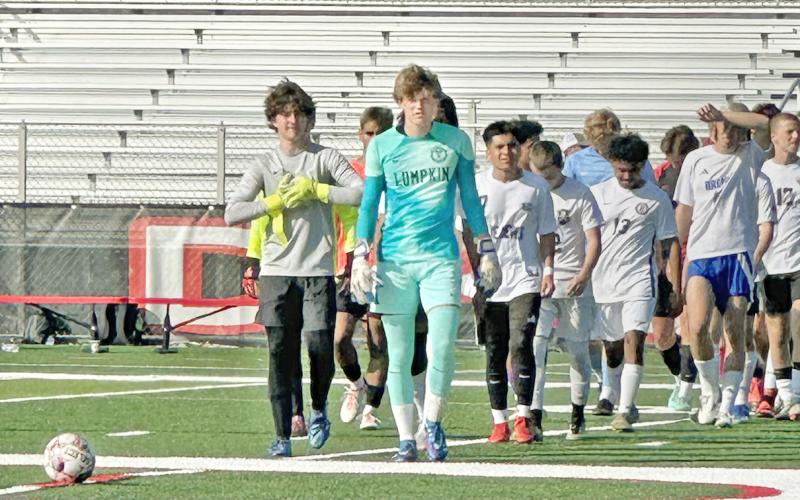 Boegner leads his team onto the field in Dalton for the GACA All-State game.