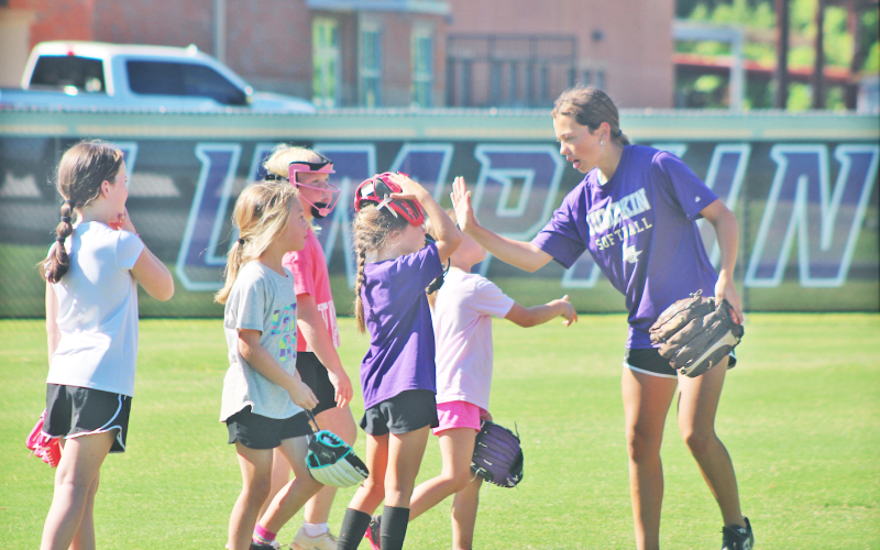 Lumpkin County player Addilaide Antonia works with the younger athletes during the softball youth summer camp.