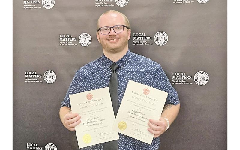 Nugget sportswriter Eligha Roper shows off new awards after the Georgia Press Association ceremony.