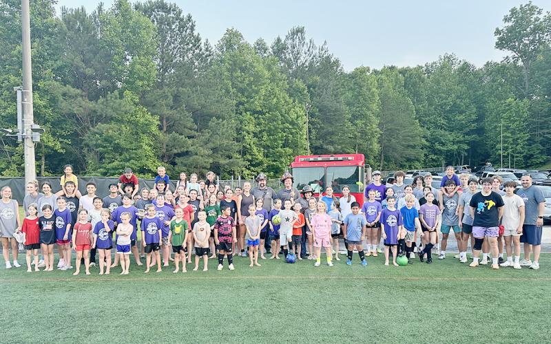 Lumpkin County soccer campers gather for a group photo after a fun drenching by the Lumpkin fire department.