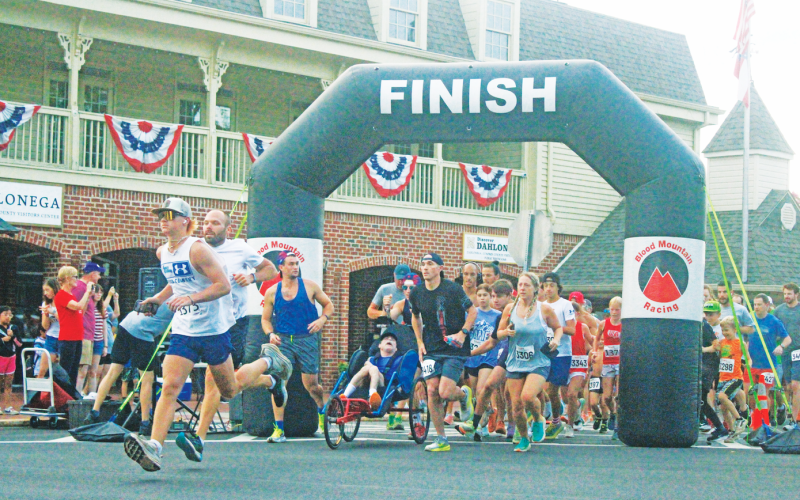 Competitors race out onto the course during the annual Fourth of July Firecracker 5K event.