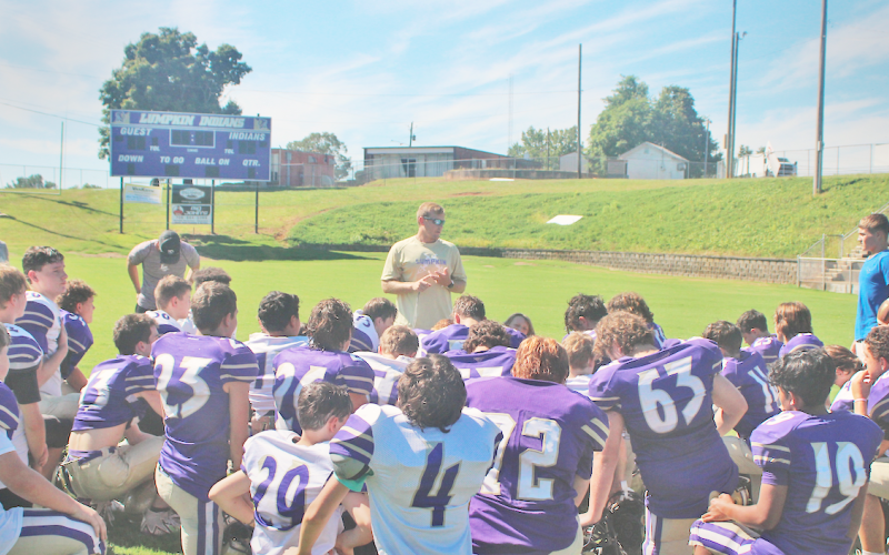 Head Coach Brenton Ruark closes out practice surrounded by his middle school team.