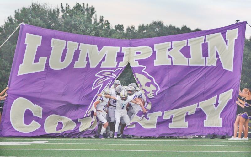 Cal Faulkner leads the Lumpkin County High School football team onto the field during a game last season.  Faulkner is looking ahead to his senior season at Lumpkin, but has already committed to Georgia Tech.