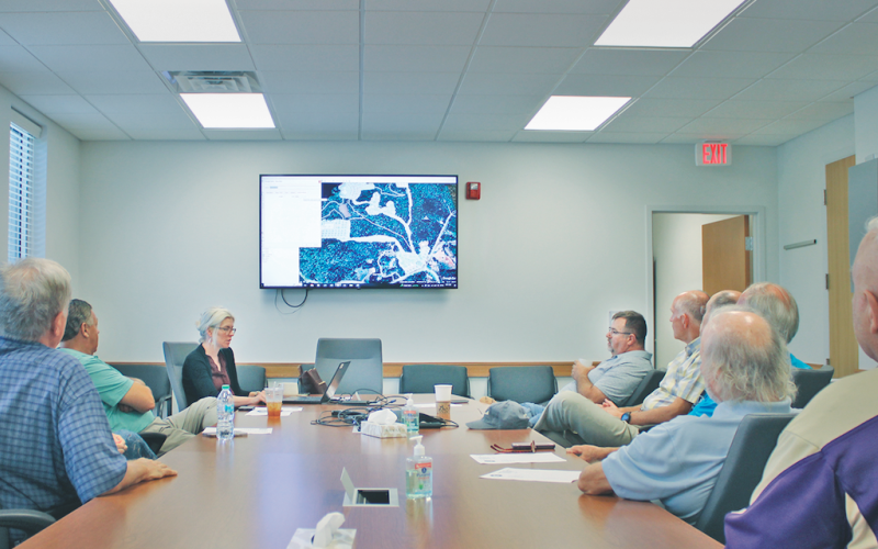 Members of the Yahoola Creek Reservoir Study Committee listen in as Planning Director Rebecca Mincey outlines the key priorities of the 2020 Reservoir Master Plan.