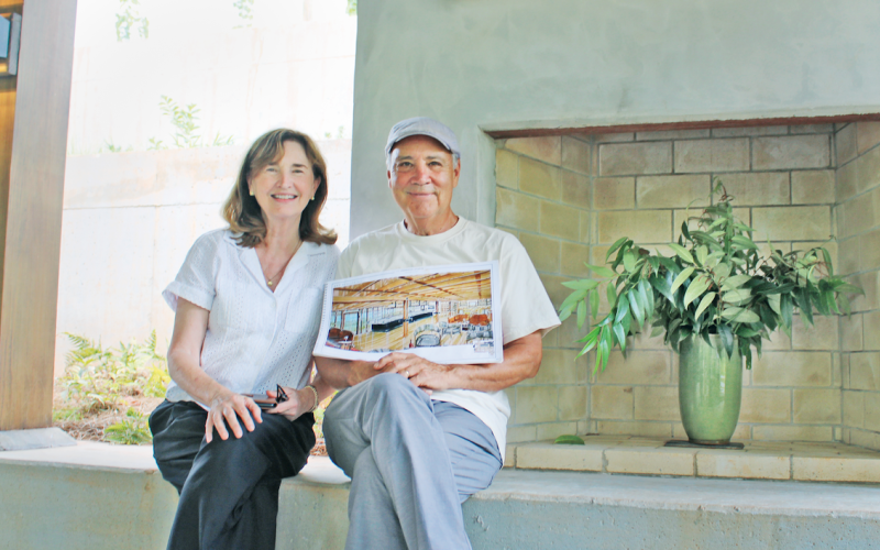Doghobble Wine Farm owners Sam Zamarripa and his wife Robin proudly display plans for the 1972 farmhouse that will become their new indoor tasting room. The winery’s namesake mountain doghobble plant can be seen in the vase to their right.