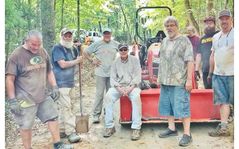 Residents living off of Syrup Mill Road pause for a quick photo during a busy day of repairs. The impromptu road crew consisted of (left to right) Don Thomas, Rick Morris, Chris Pisarik, Jack Harshbarger, Patrick Hayes, Edward Wells, Austin Hayes and Dave McDowell. Not pictured are Michell Pisarik, Lee Goff, Amanda Thomas and Fred Noble.