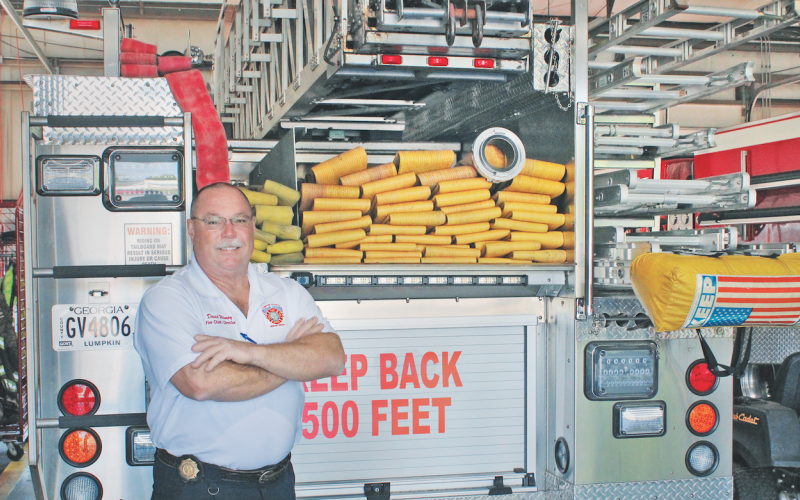Chief David Wimpy stands next to a ladder truck parked at Fire Station 1. Lumpkin County Emergency Services is set to receive a brand new platform ladder truck with a two-man bucket at the start of 2025.