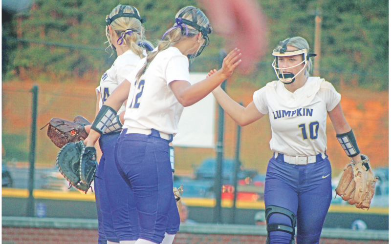 Lumpkin’s LaDalle Carpenter high-fives teammates as she takes the field against Dawson County.