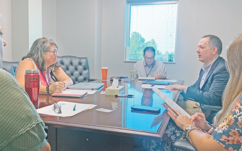 Georgia Safe Routes to School program coordinator Nick Anderson, second from right, discusses the details of the upcoming LCMS Walking School Bus event with, from left, Transportation Director Lynn White, LCMS Principal Libbie Armstrong, Chief Operations Officer Greg Trammell and Cottrell Elementary School Principal Stacie Gerrells. More Safe Route events, like an elementary school bike rodeo, are in the works for later in the school year.