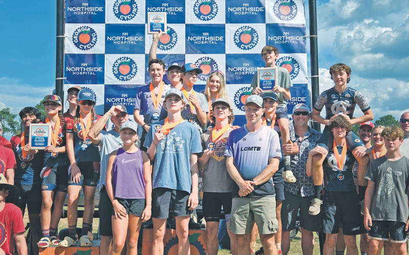 The Lumpkin County mountain bike team (center) stands atop the podium.