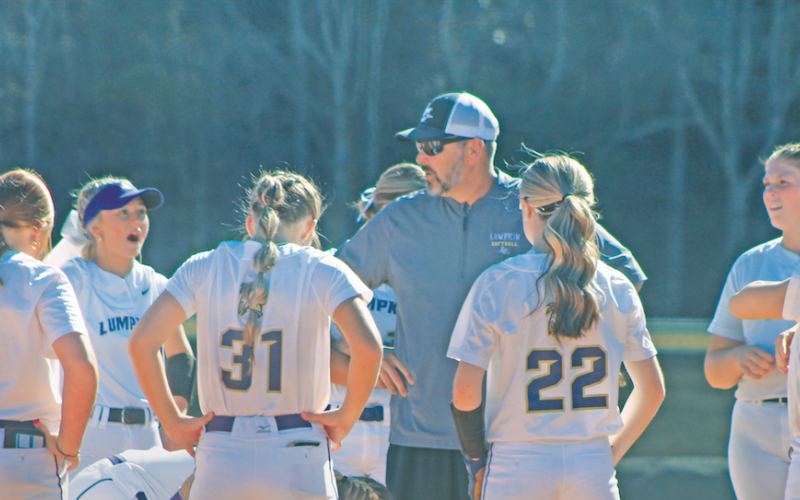 Coach Joseph Jones rallies his players ahead of their State Playoff game against Jefferson.