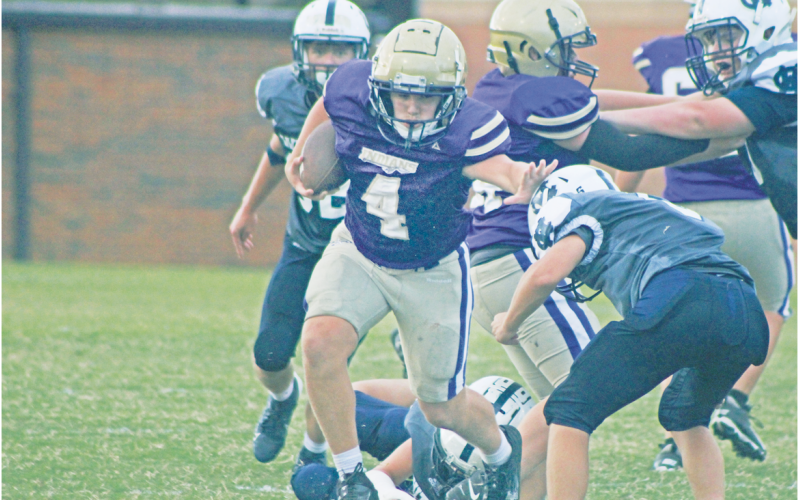 Lumpkin County’s Ben Monroe stiff-arms his way through White County defenders.