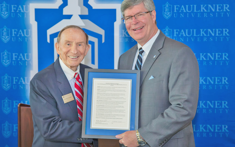 Faulkner University President Mitch Henry, right, presents local philanthropist Bud Stumbaugh with a plague commemorating the recent establishment of The Stumbaugh School of Risk Management &amp; Insurance.