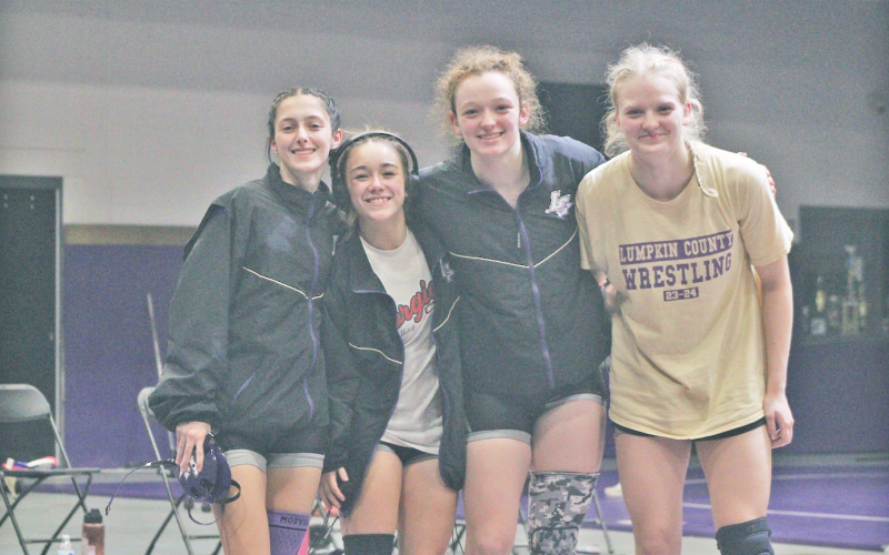 Lumpkin County team captains Kylee Melton, Cadence Grulla, Nora Garbuzovas and Greta Garbuzovas gather together before their match against Chestatee.