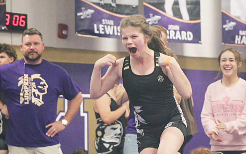 Darlene Steinberg celebrates an exhibition match victory at this week’s middle school Tri-Meet.