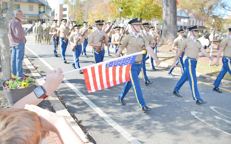 Local residents salute the Blue Ridge Rifles and the cadets from the University of North Georgia during last week’s Veterans Day parade in Dahlonega. (Photo by John Bynum)