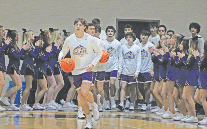 TJ Gaddis brings the team onto the court against Dawson. Gaddis led the Indians in scoring with 24 points against the Tigers.