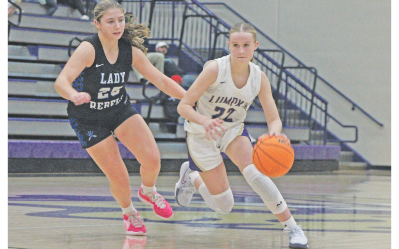Lumpkin County’s Anna Davis plows her way down the court against the Rebels.