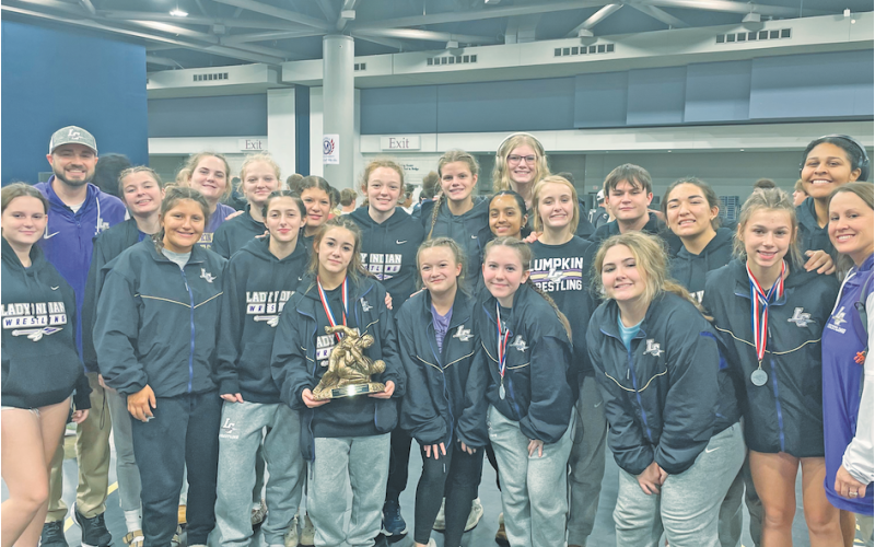The Lumpkin County girls wrestling squad gathers following their first place performance in Alabama.