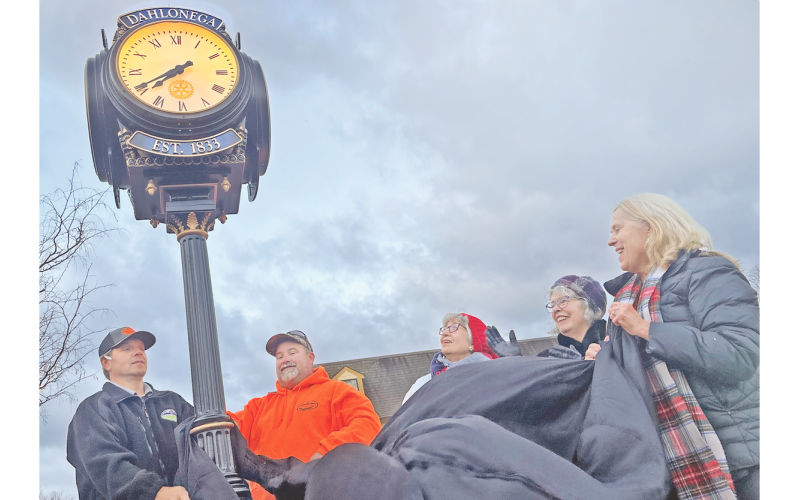 The recently donated downtown Rotary Club clock is officially unveiled Thursday morning with the assistance of, from left, Troy Armstrong, Justin Priest, past Rotary president Diane Bates, Mayor JoAnne Taylor and Rotary Assistant Governor Barbara Myers Mason.