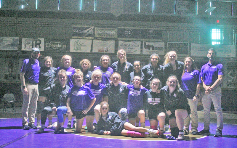 The Lumpkin County girls wrestling team celebrates their victory after their meet against Burke County.