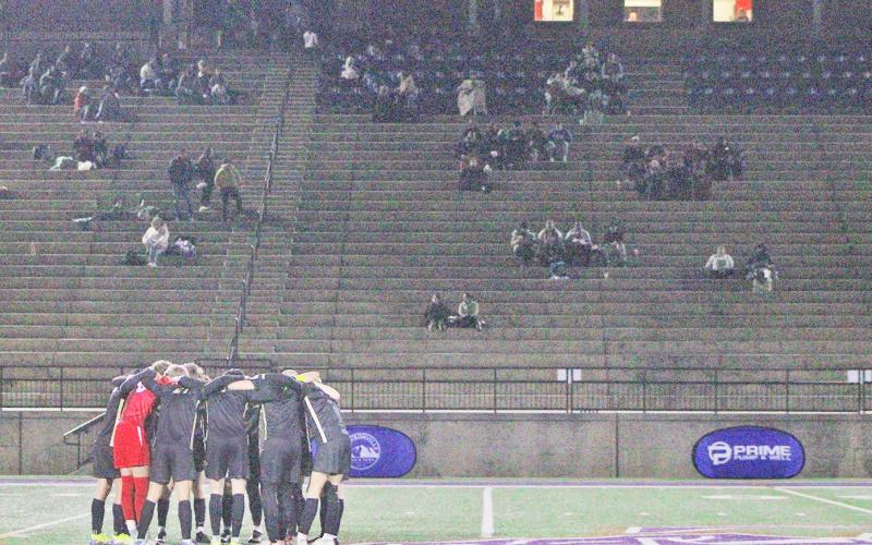 The Lumpkin County High School boys soccer team takes a moment to focus before the game.