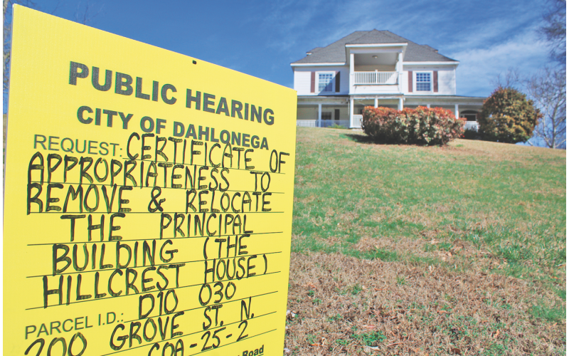 A sign on the lawn of the Hillcrest House notifies the public of a proposal to relocate the historic building. The structure is a well-known landmark to frequent passers-by on North Grove Street.