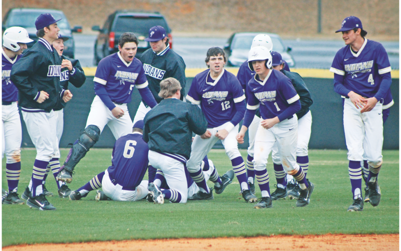 The Lumpkin County High School baseball team storms the field following their walk-off win against Fannin.