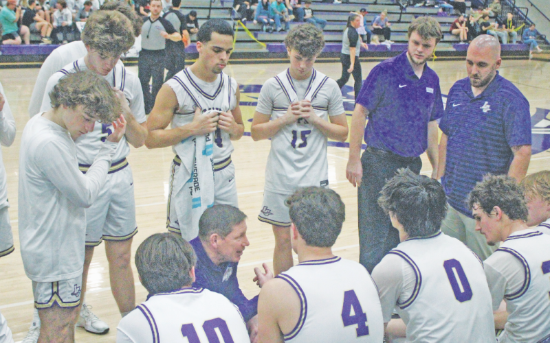 Lumpkin County boys basketball head coach Chris Faulkner talks strategy with his team during a recent home game.