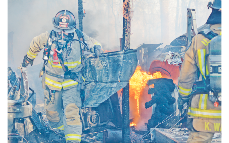Lumpkin County firefighters work to contain the burning remains of a structure fire off Camp Wahsega Road. (photo by John Bynum)