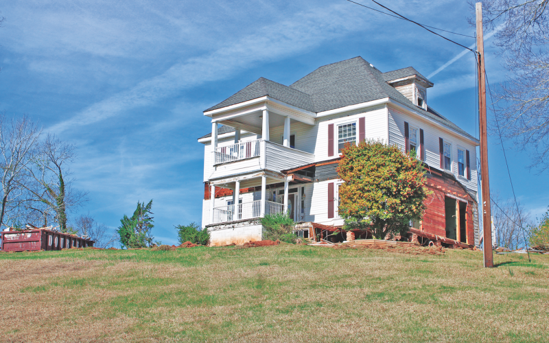 A crew from Bent Nails Construction has been working to remove the porches and any additions to the original 1898 Hillcrest House in preparation for its eventual relocation.