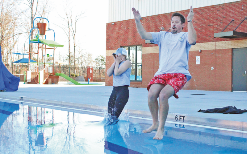 Assistant County Manager Rebecca Mincey and Commissioner Tucker Greene take a plunge into the icy cold waters of the Pinetree pool.