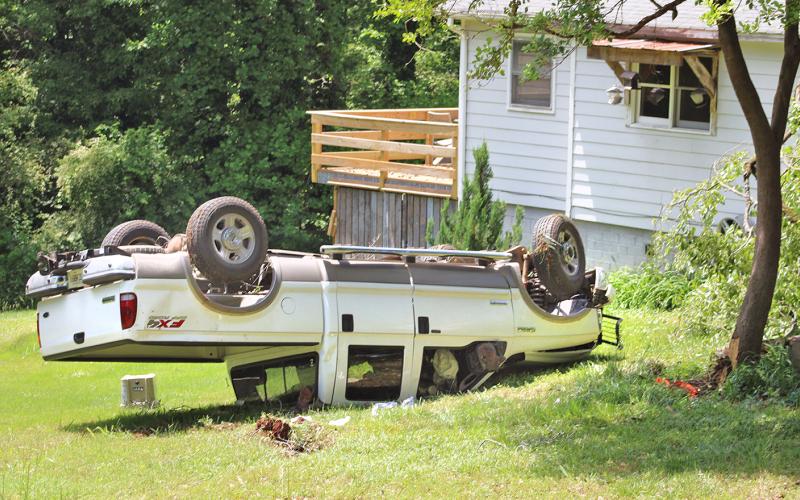 An out-of-control truck swerved off of Camp Wahsega Road last Thursday, drove into a tree and came to rest upside down. Postal carrier Mike Boyce, not pictured, was on the scene and was quick to help the accident victim who came away from the crash with minor injuries.