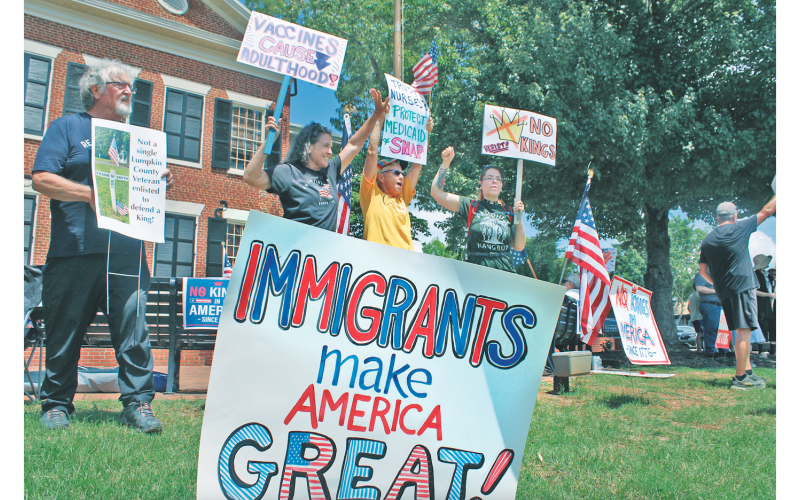 Participants in Saturday’s “No Kings” protest included (from left) Lumpkin County Democratic Party Chair Roger Smith, Bobbi Martin, Katherine Russell and Destiny Phagan.